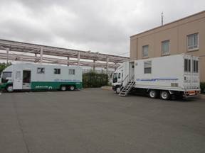 a photo of JAEA's two vehicles carrying a whole-body counter each dispatched and located at Onahama Coal Center in Iwaki City