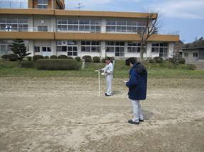 a photo of JAEA staff in radiation monitoring on school ground