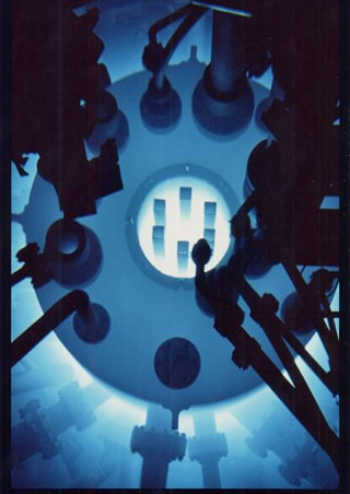 The reactor core and heavy water tank glowing with the blue light of Cherenkov radiation